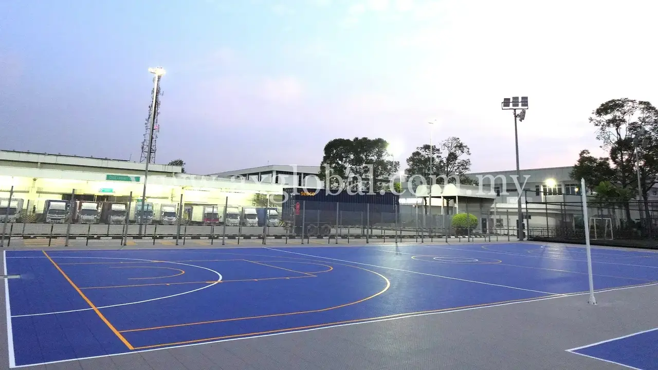 Blue outdoor multipurpose court tiles with coloured line markings at Perodua Rawang